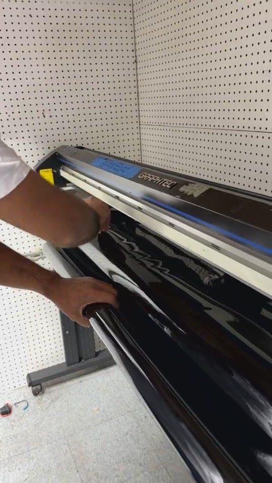 Cut window film being lifted off the plotter