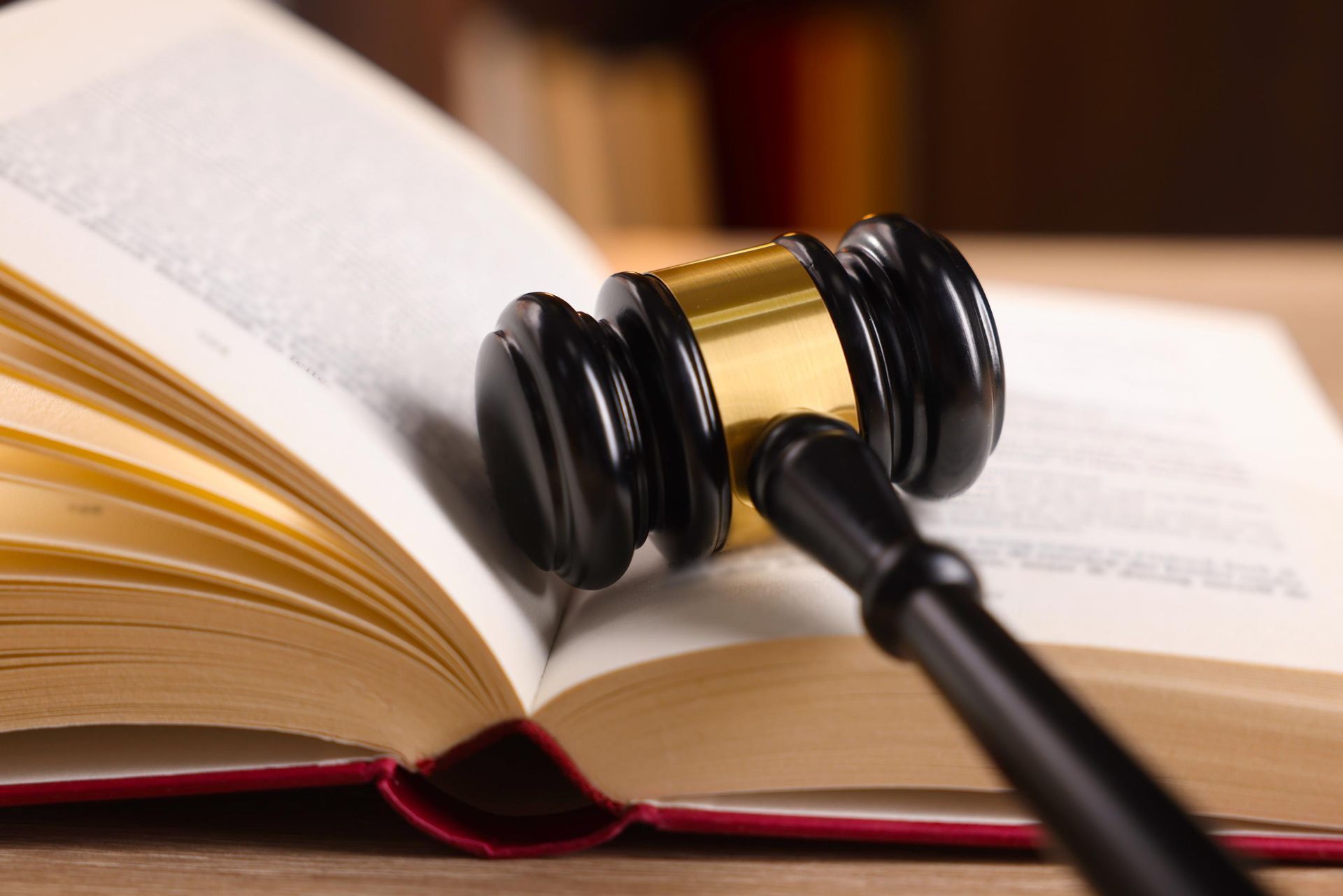 Judge’s gavel resting on an open law book with pages fanned out