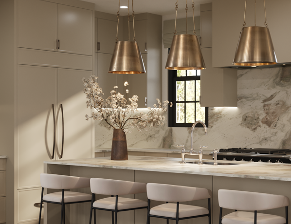 Modern kitchen with marble countertops, gold pendant lights, and bar stools.