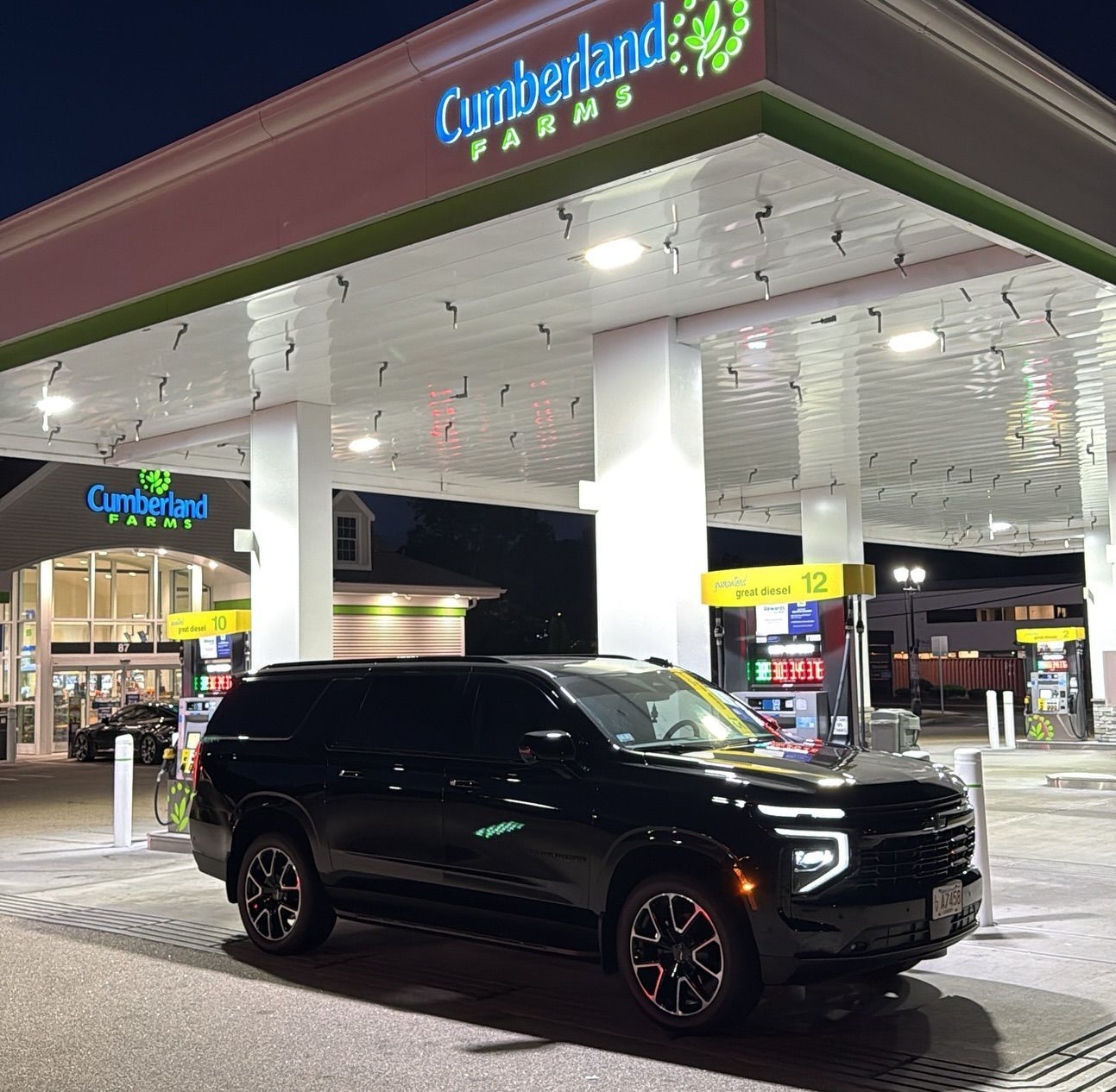 Black SUV at a Cumberland Farms gas station at night