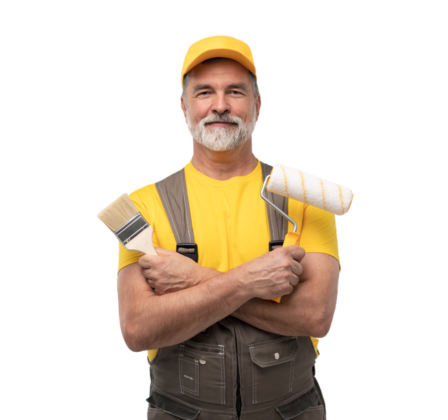 Smiling painter in yellow shirt and cap, holding two paint rollers with arms crossed