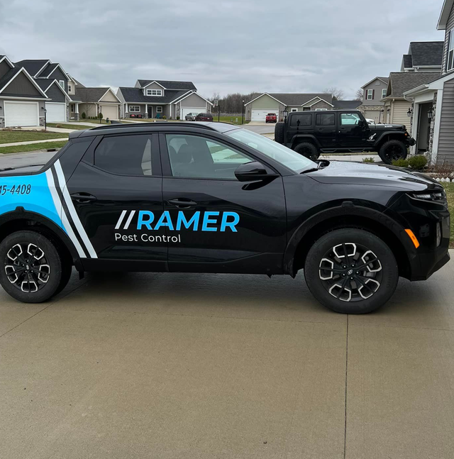 Black Ramer Pest Control branded SUV parked on a suburban street
