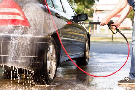 worker using a pressure washer