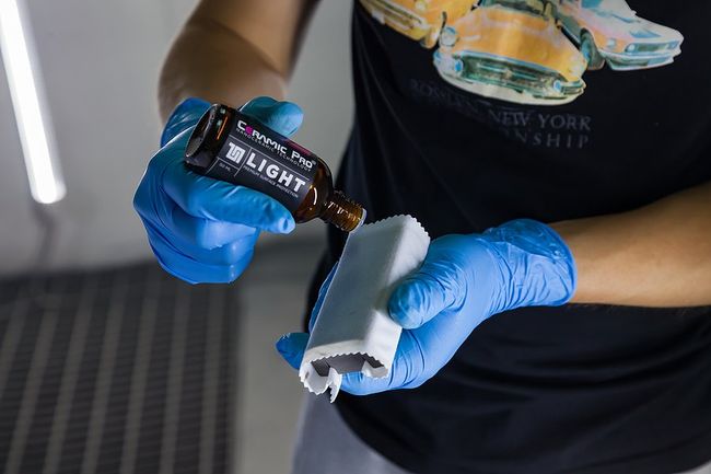 Ceramic Coating Tech applying to vehicle