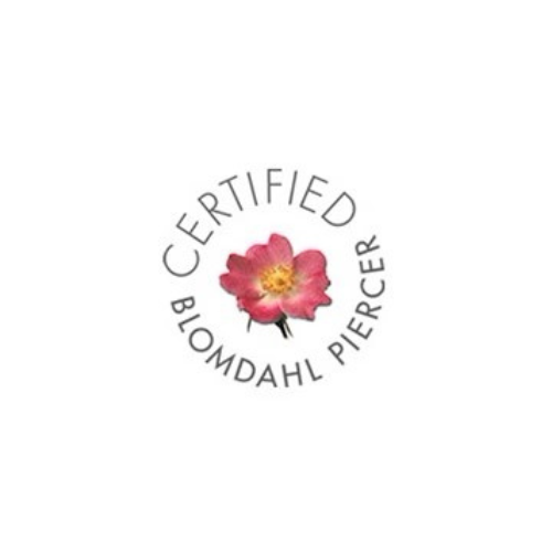 Circular certification logo with pink flower and the words “CERTIFIED BIOMDAHL PIERCE”