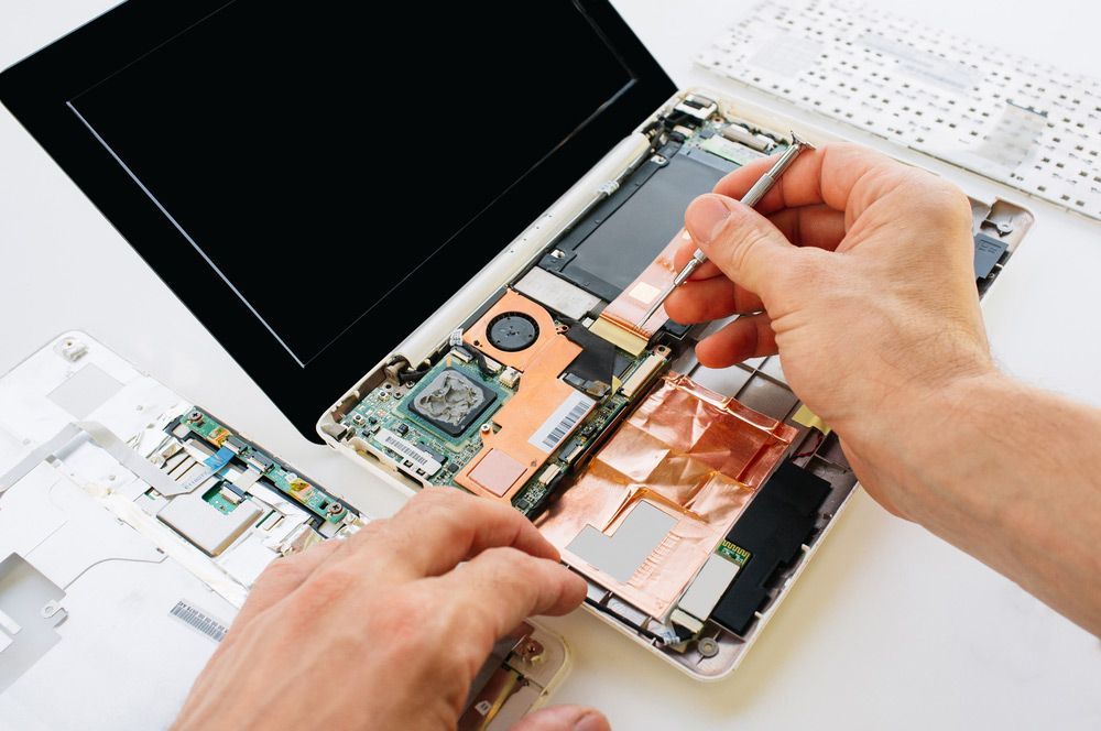 Technician Repairing The Motherboard Of The Laptop — Essential Computer Repairs In Buderim QLD