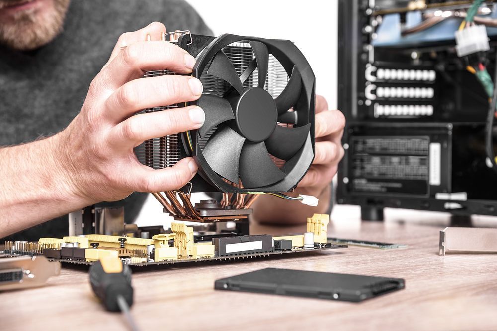 Technician Installs Cooling System Of Computer — Essential Computer Repairs In Sunshine Coast QLD
