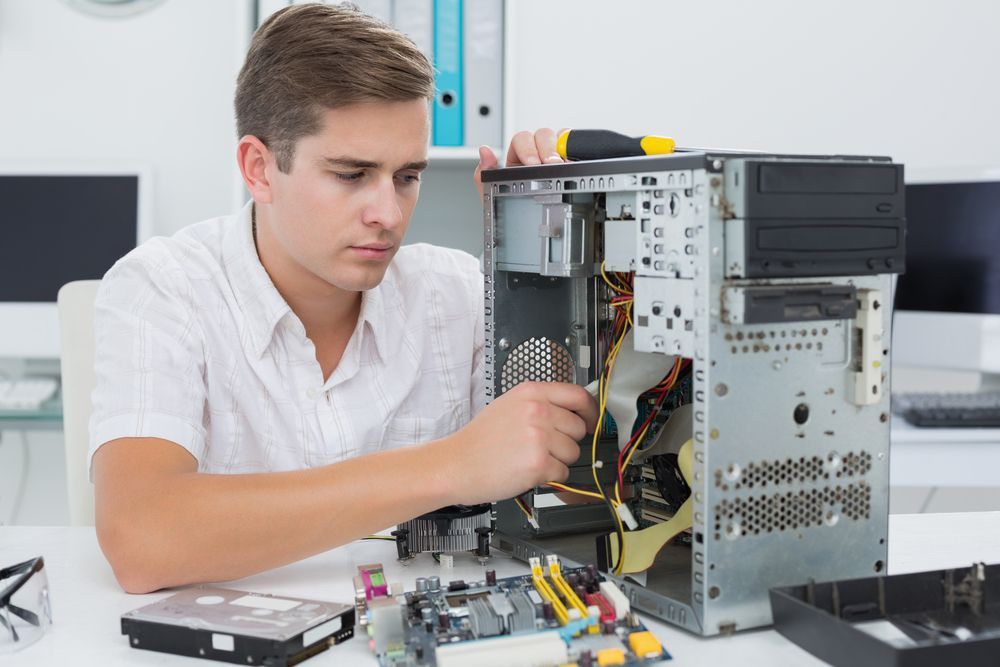 Technician Repairing On Broken Computer On The Table — Essential Computer Repairs In Buderim QLD