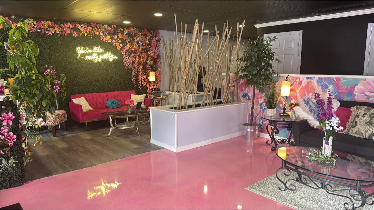 A living room with a pink floor and a couch.