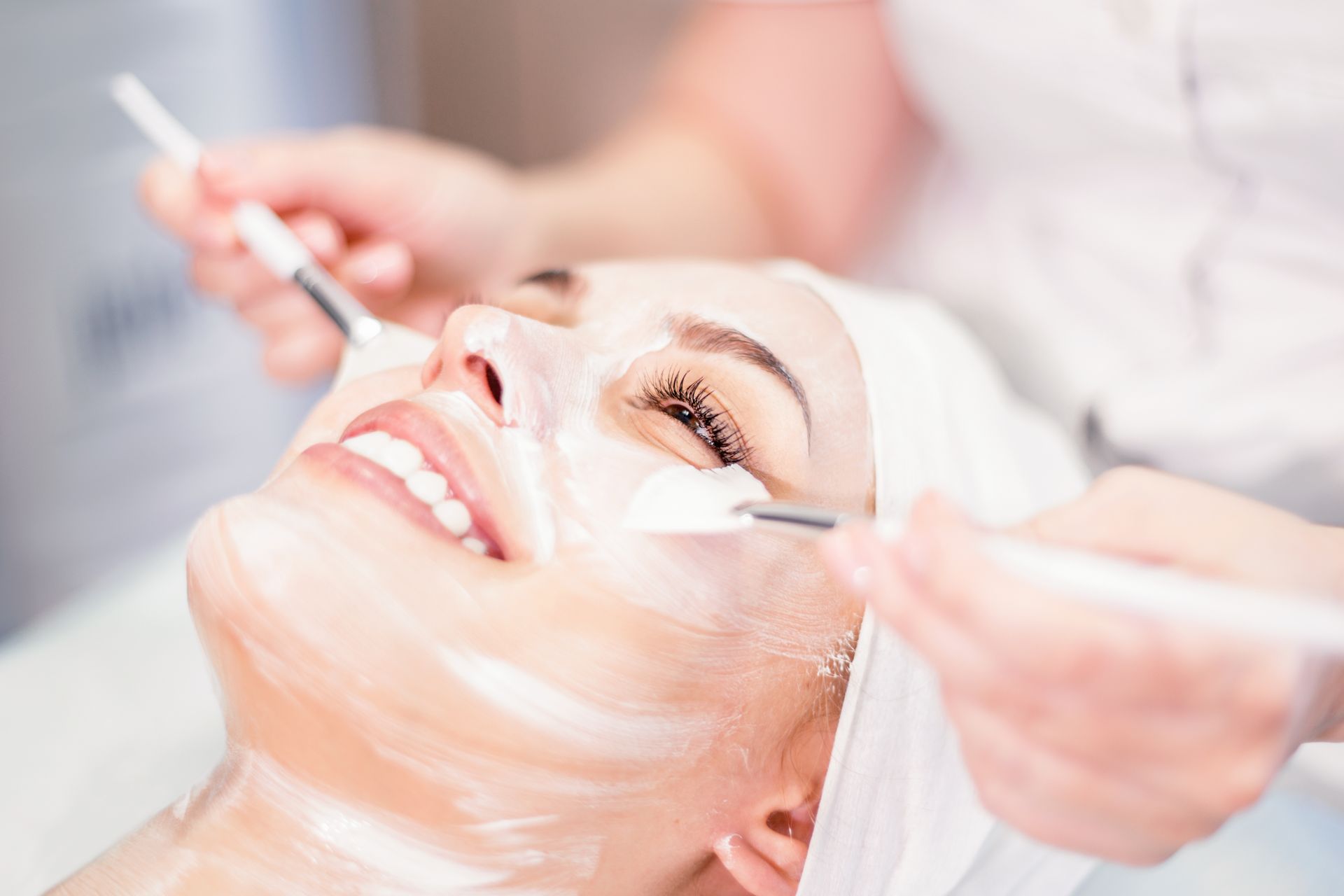 A woman is getting a facial treatment at a spa.