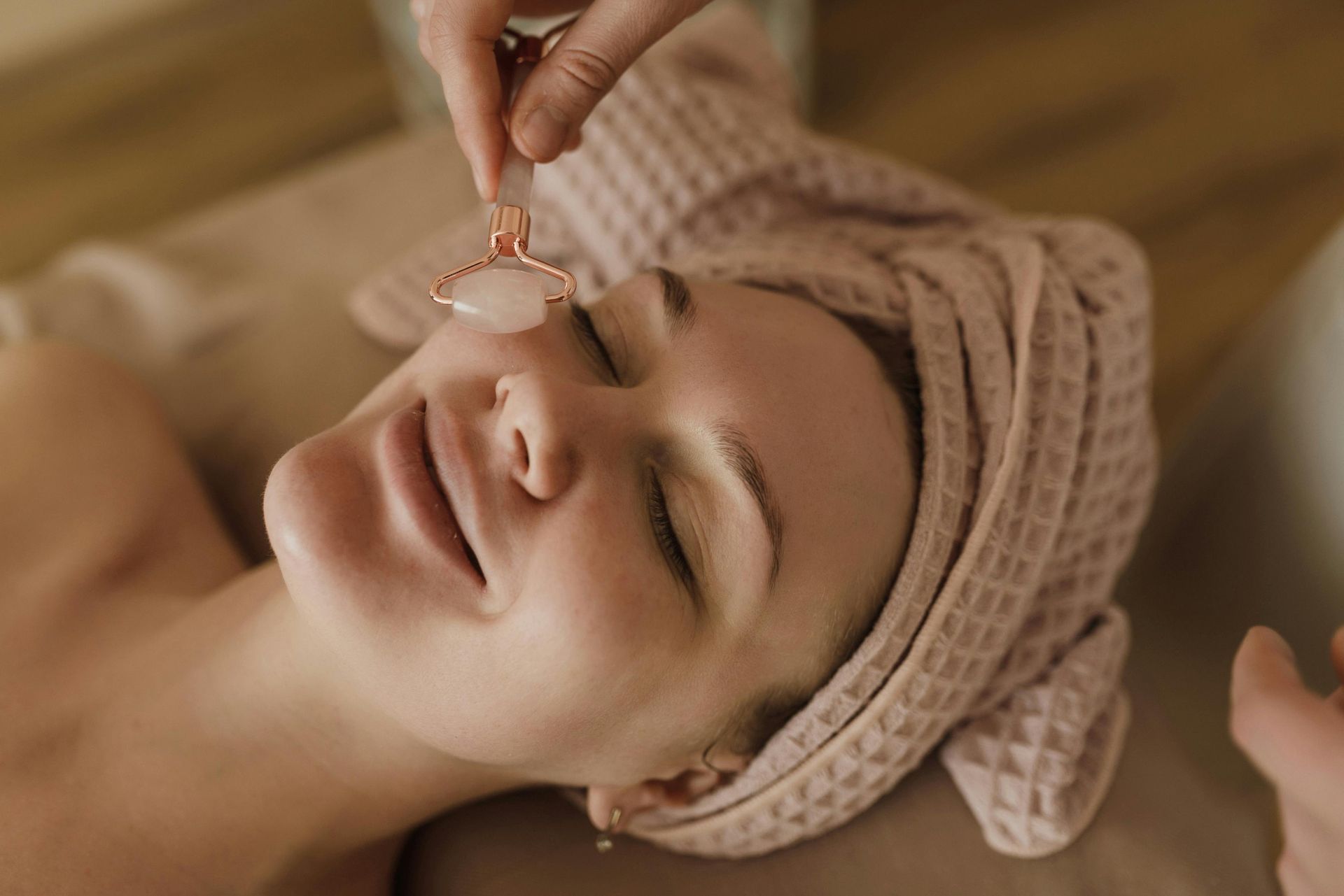A woman is getting a facial treatment at a beauty salon.
