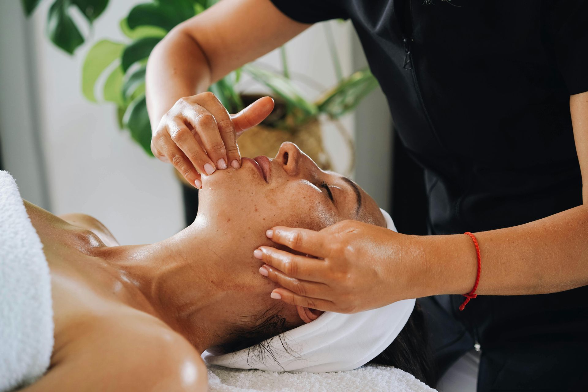 A woman is getting a facial treatment at a spa.