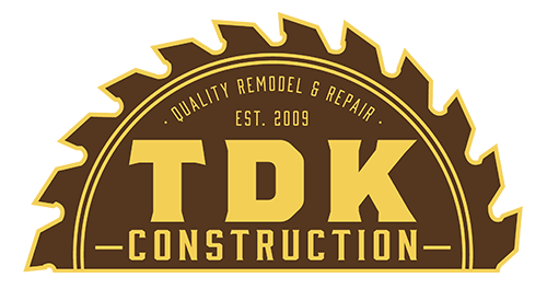 TDK Construction logo: yellow text