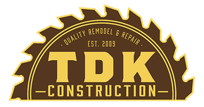 TDK Construction logo: yellow text