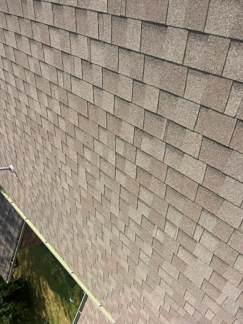 Brown asphalt shingle roof, angled view.
