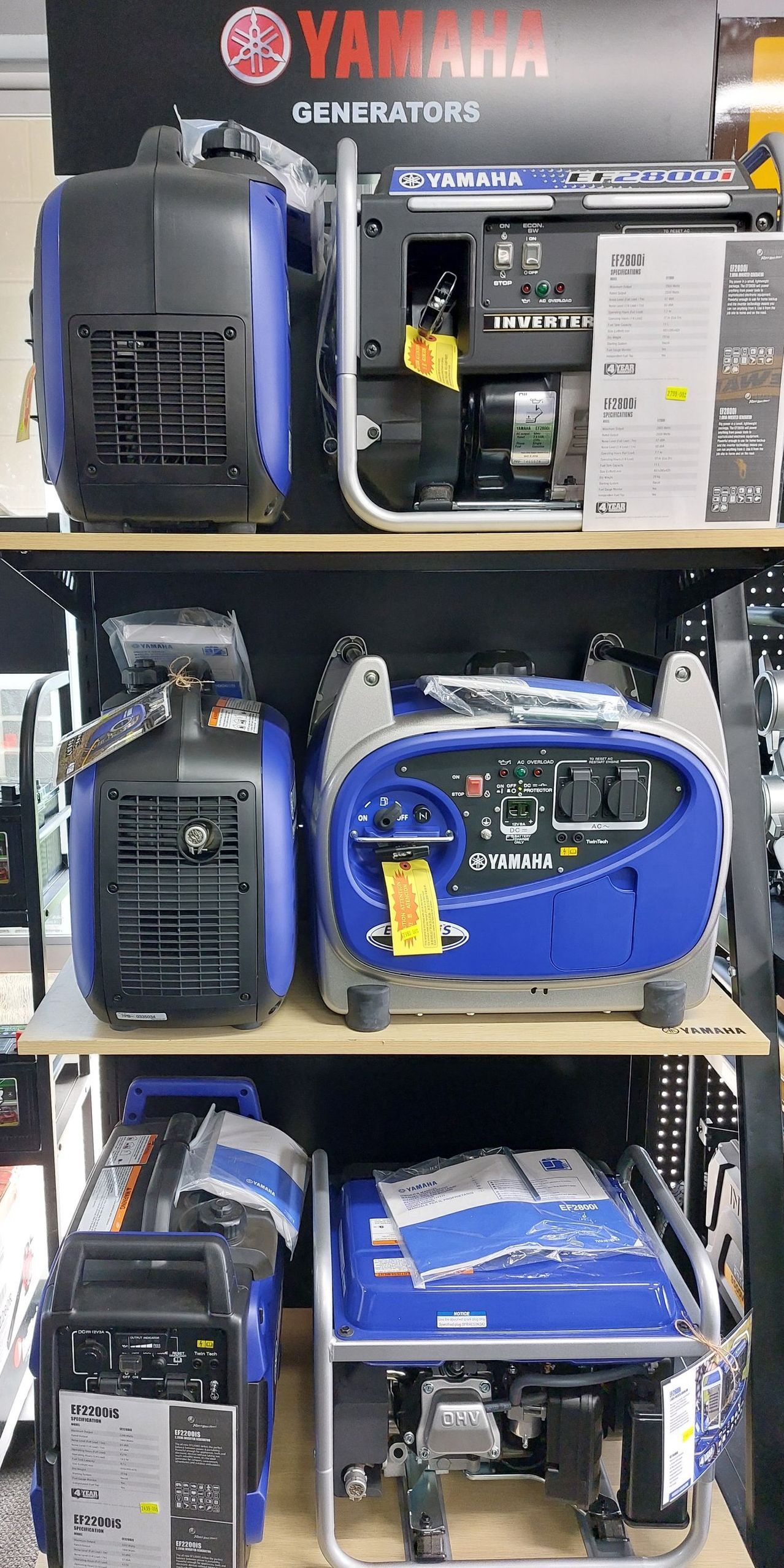 Multiple Blue Generators on Shelves in a Store — Professional Small Engines in Aitkenvale, QLD