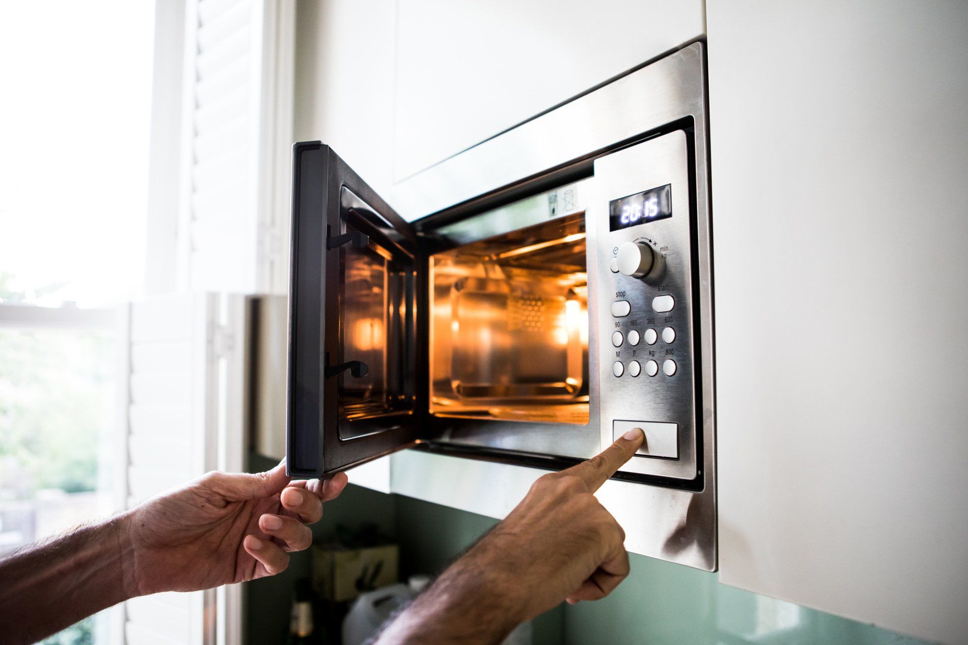 Person Using Microwave — Utica, MI — Doc's Appliance Service Person Using Microwave — Utica, MI — Doc's Appliance Service