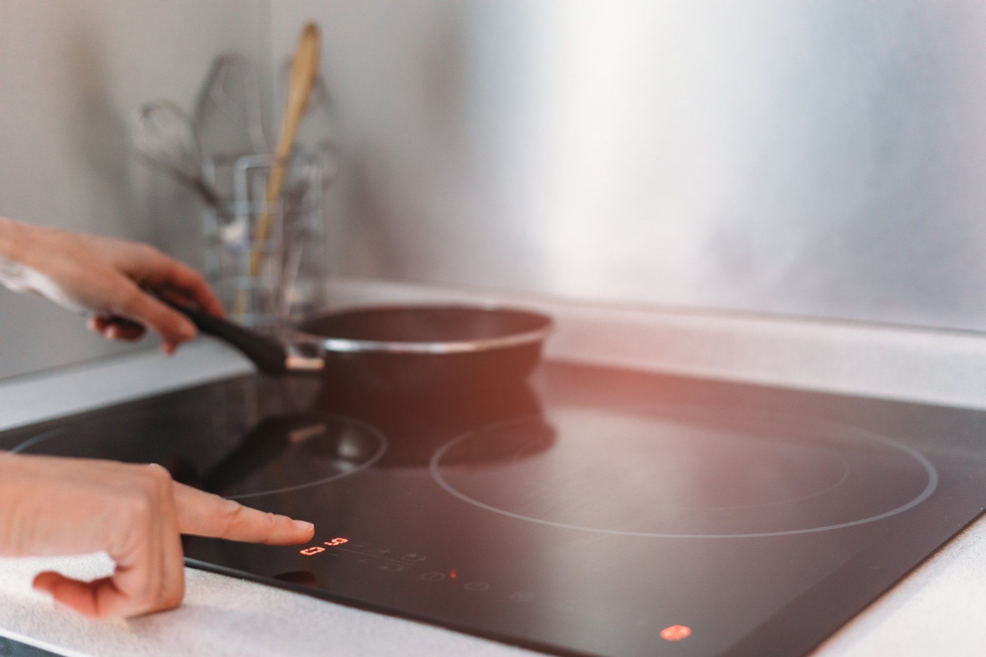 Person Using Electric Stove — Utica, MI — Doc's Appliance Service Person Using Electric Stove — Utica, MI — Doc's Appliance Service