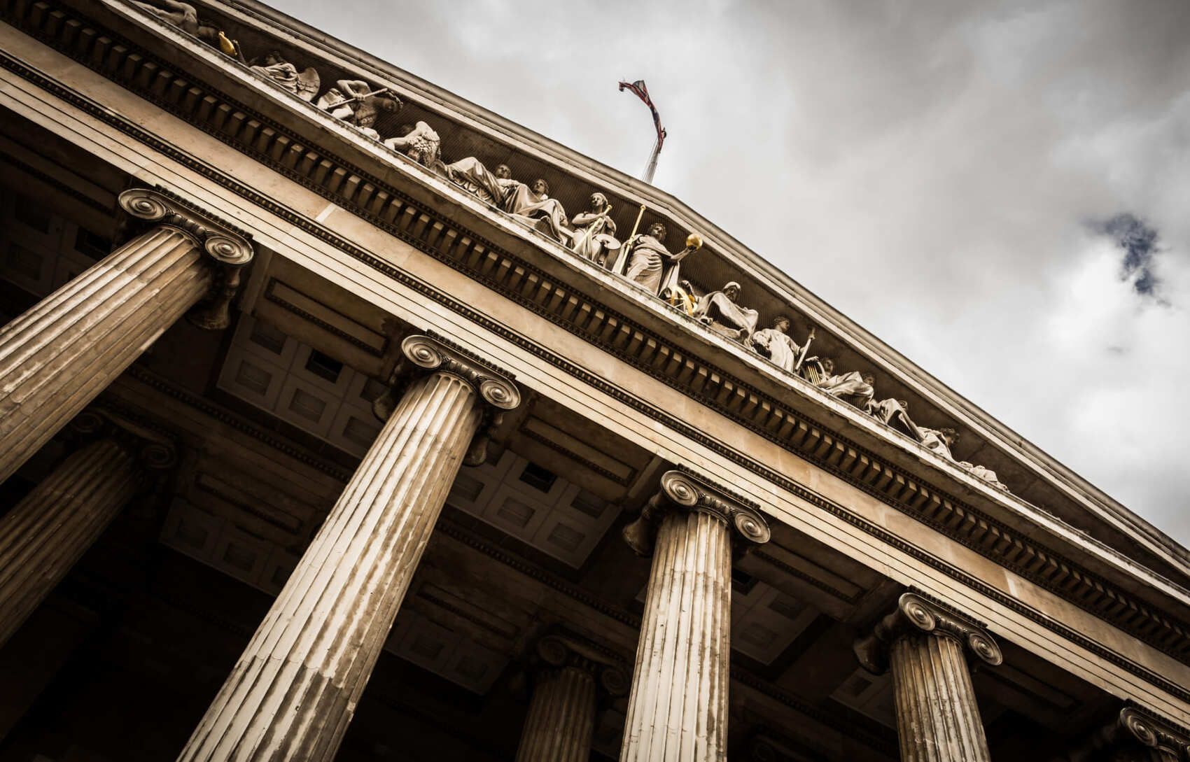 Looking up at the top of a building with columns