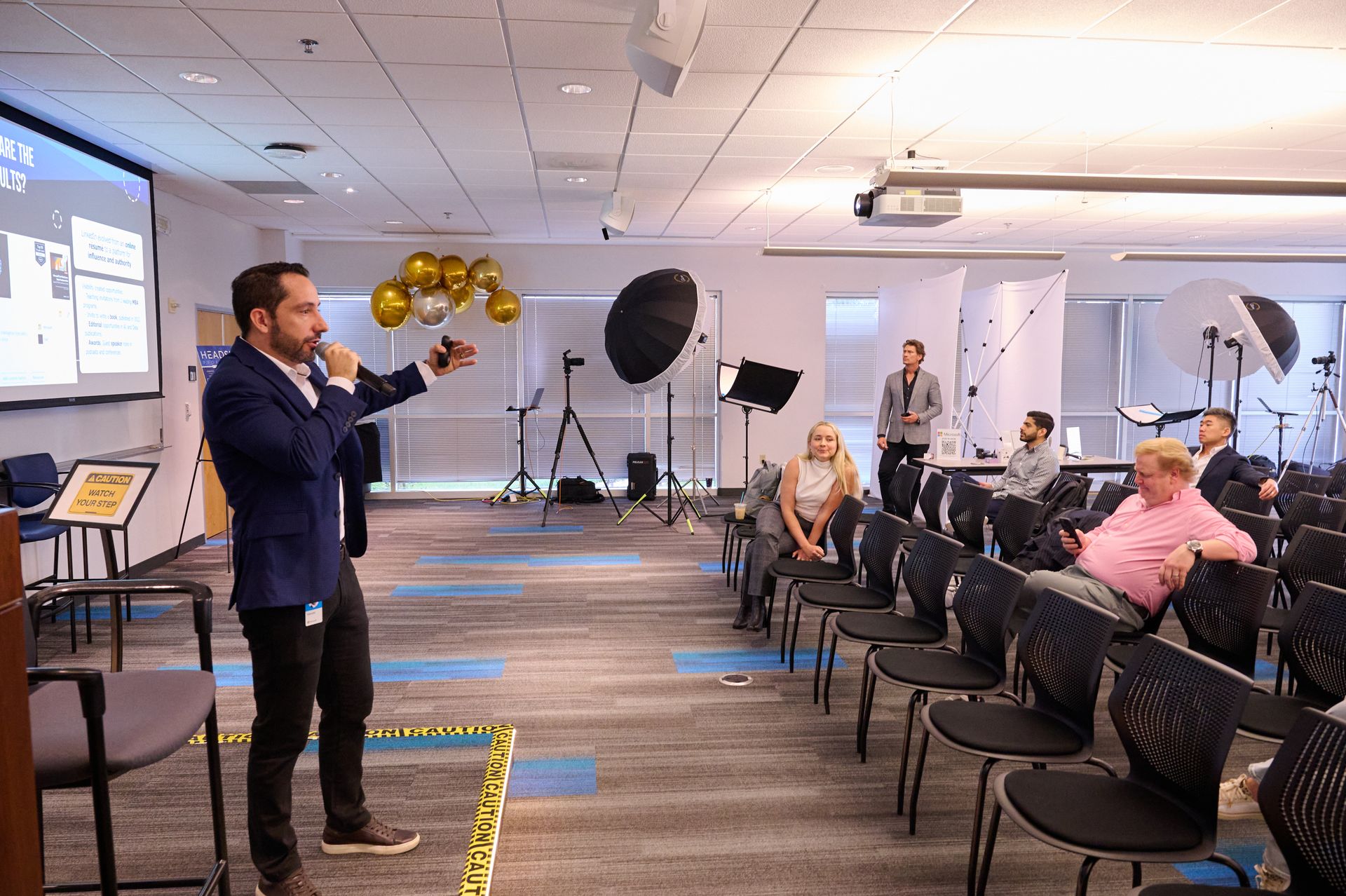 A man is giving a presentation to a group of people in a conference room.
