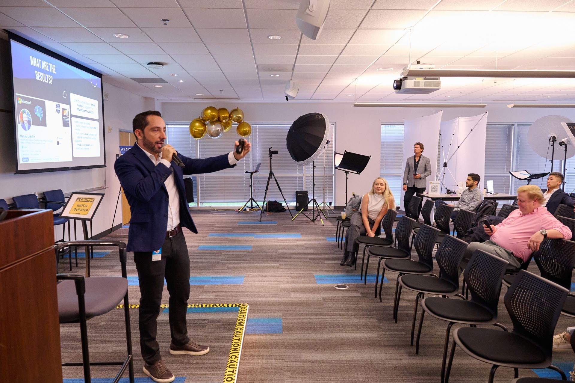 A man is giving a presentation in front of a group of people in a conference room.