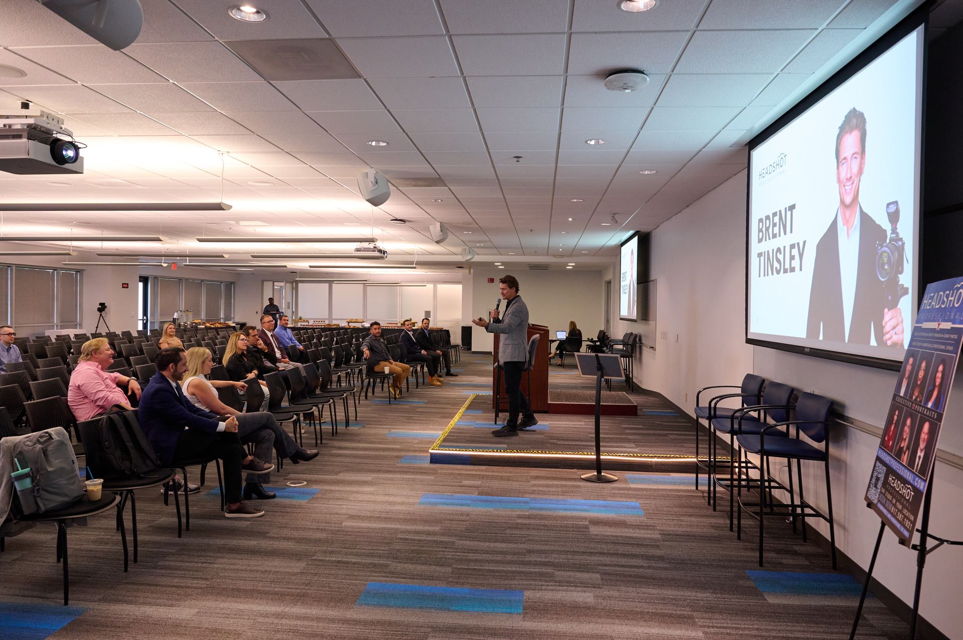 A man is giving a presentation in front of a large audience.
