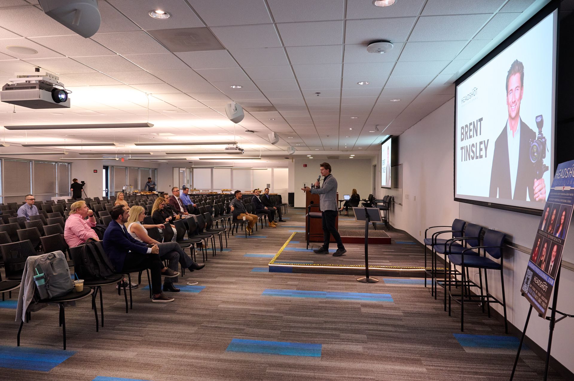 A man is giving a presentation in front of a large audience.