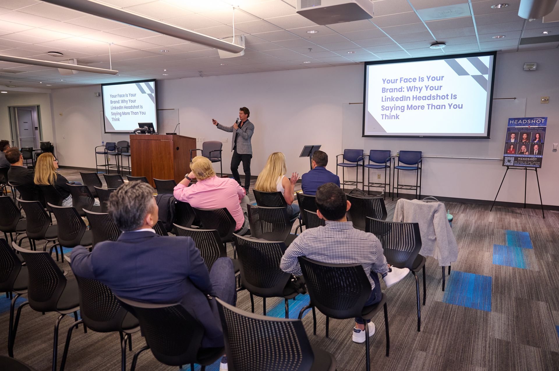A man is giving a presentation to a group of people in a conference room.