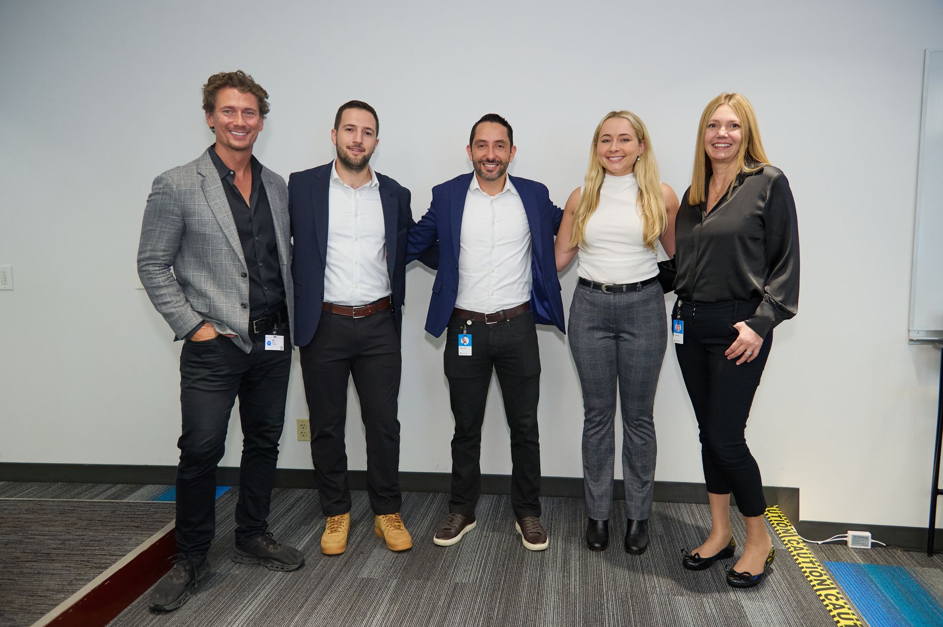 A group of people are posing for a picture together in a room.