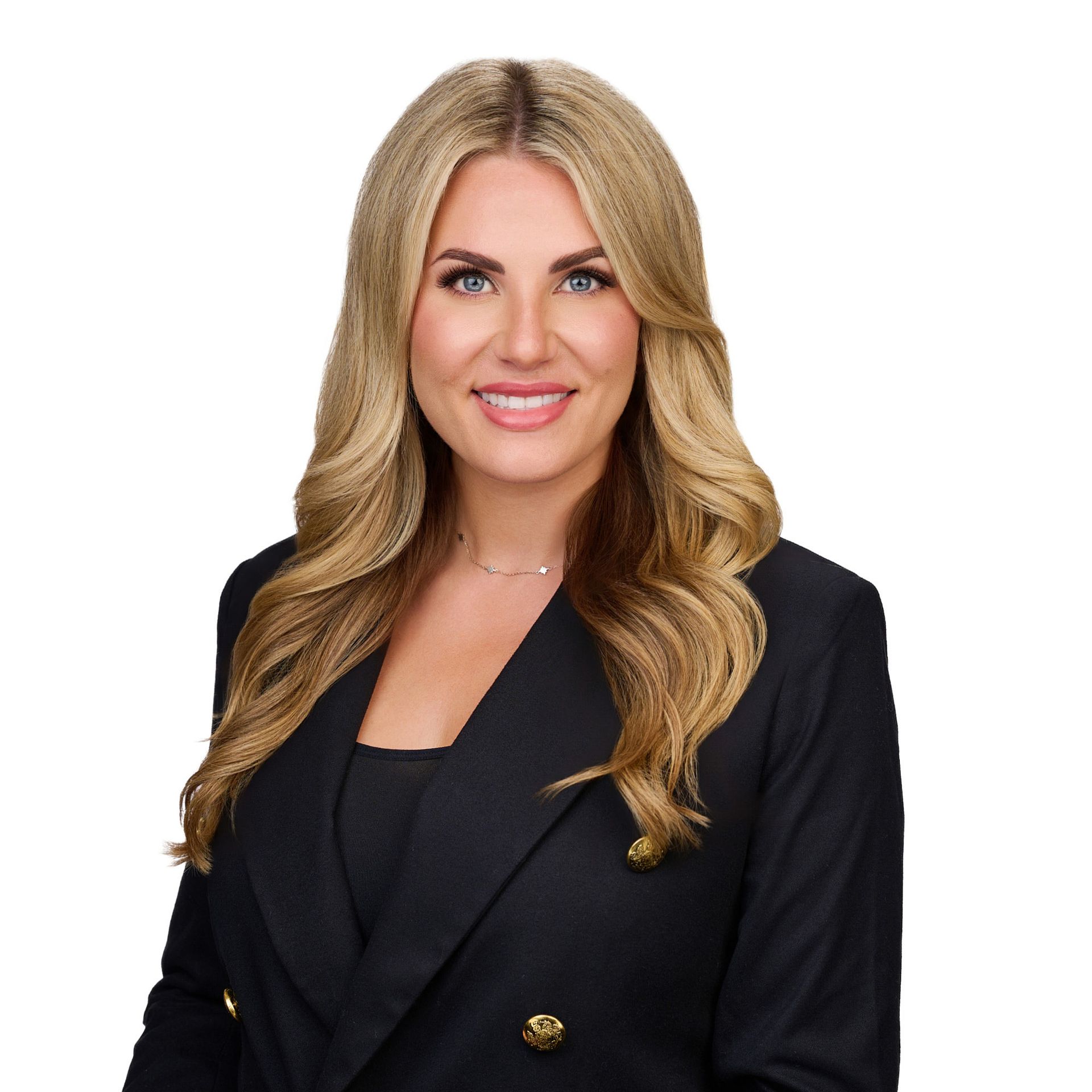 A woman in a black jacket is smiling for the camera