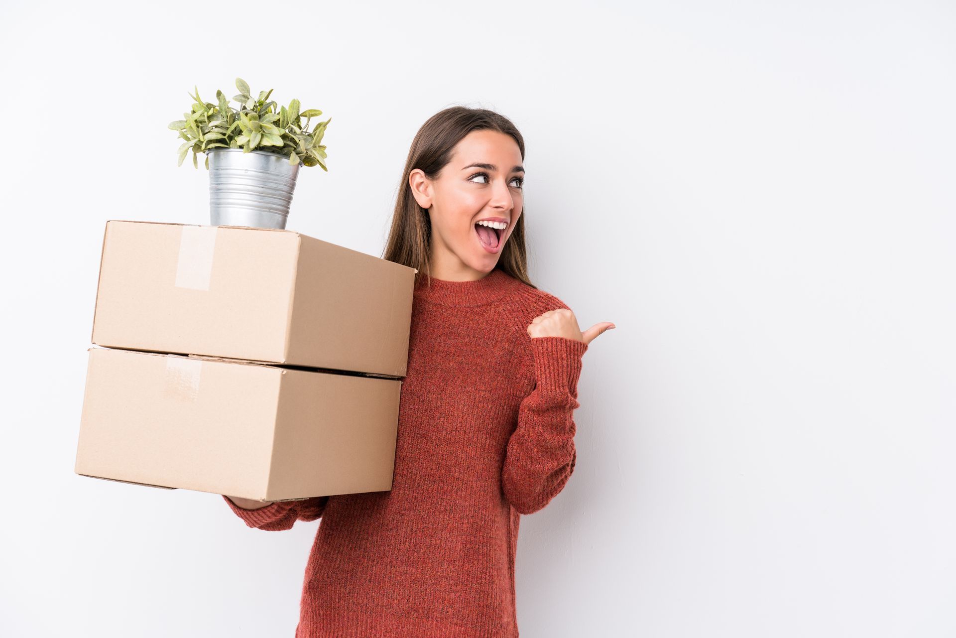 Happy woman carrying boxes