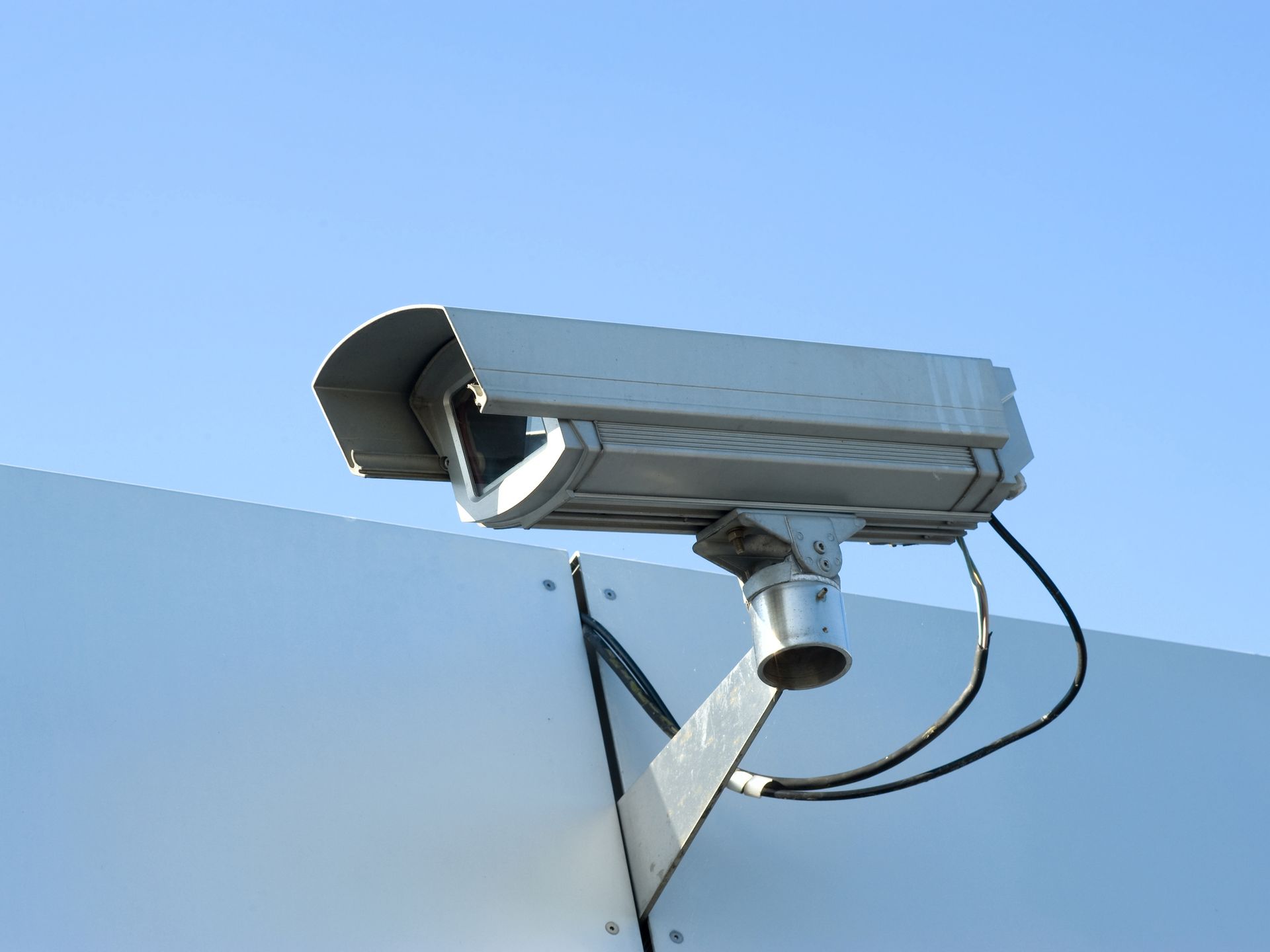 Mounted surveillance camera and sky. Mounted surveillance camera and sky.