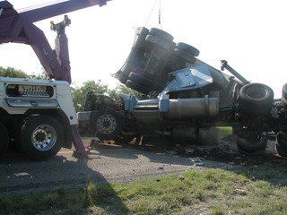 Towing company assisting with auto accident recovery along a highway in San Angelo, TX