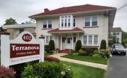 Terranova exterior sign and two-story house with red roof and landscaped front yard