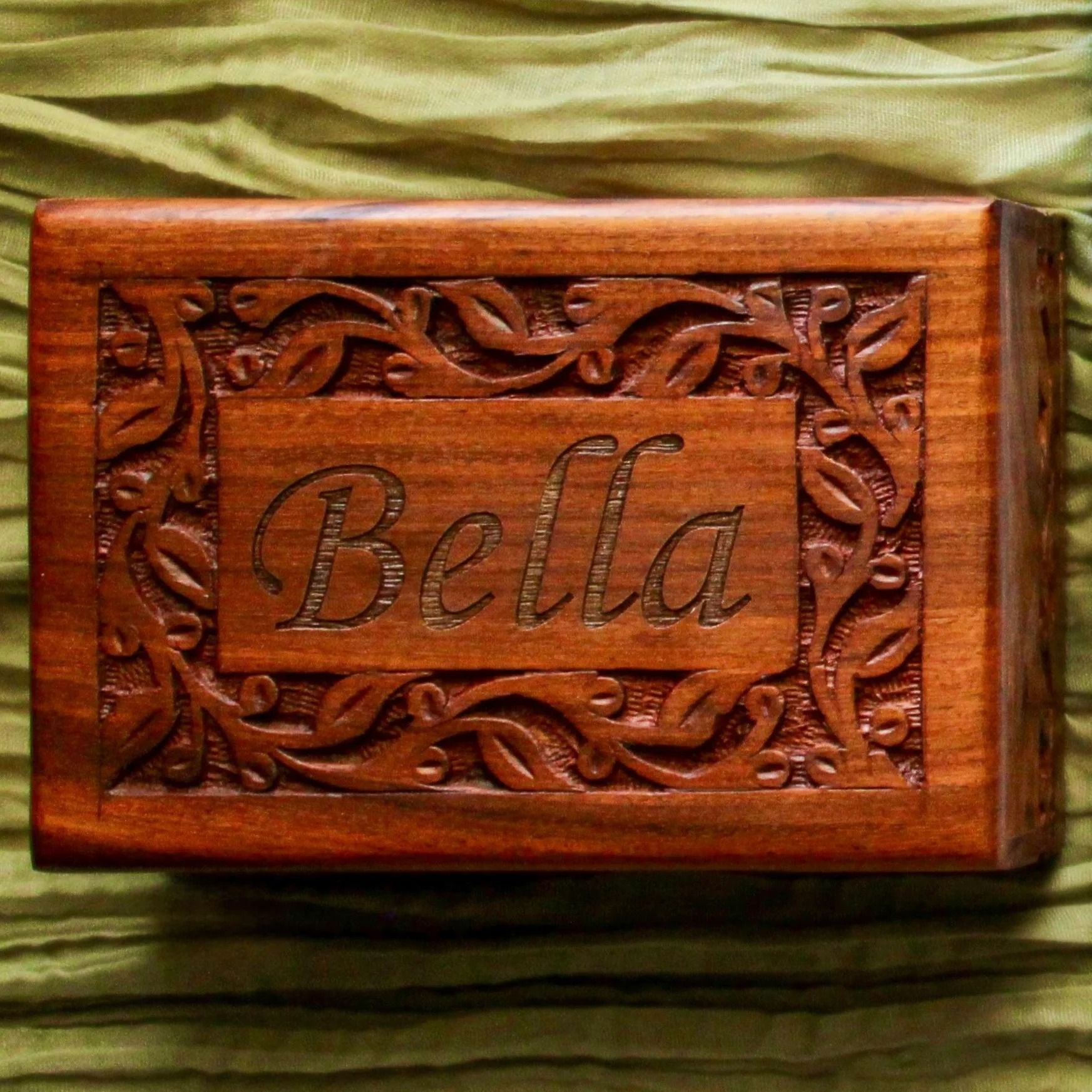 Carved wooden box with the name “Bella” engraved on the lid.