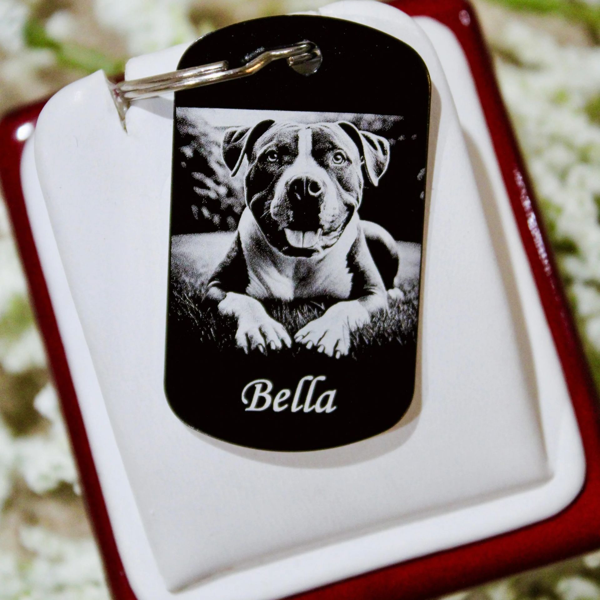 Black dog tag with a bulldog photo and the name “Bella” on a white and red background