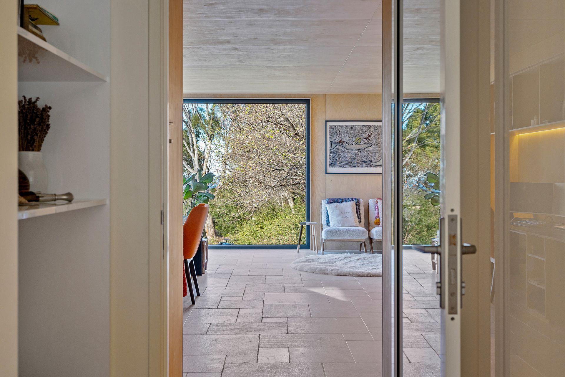 A view of a living room through a glass door.
