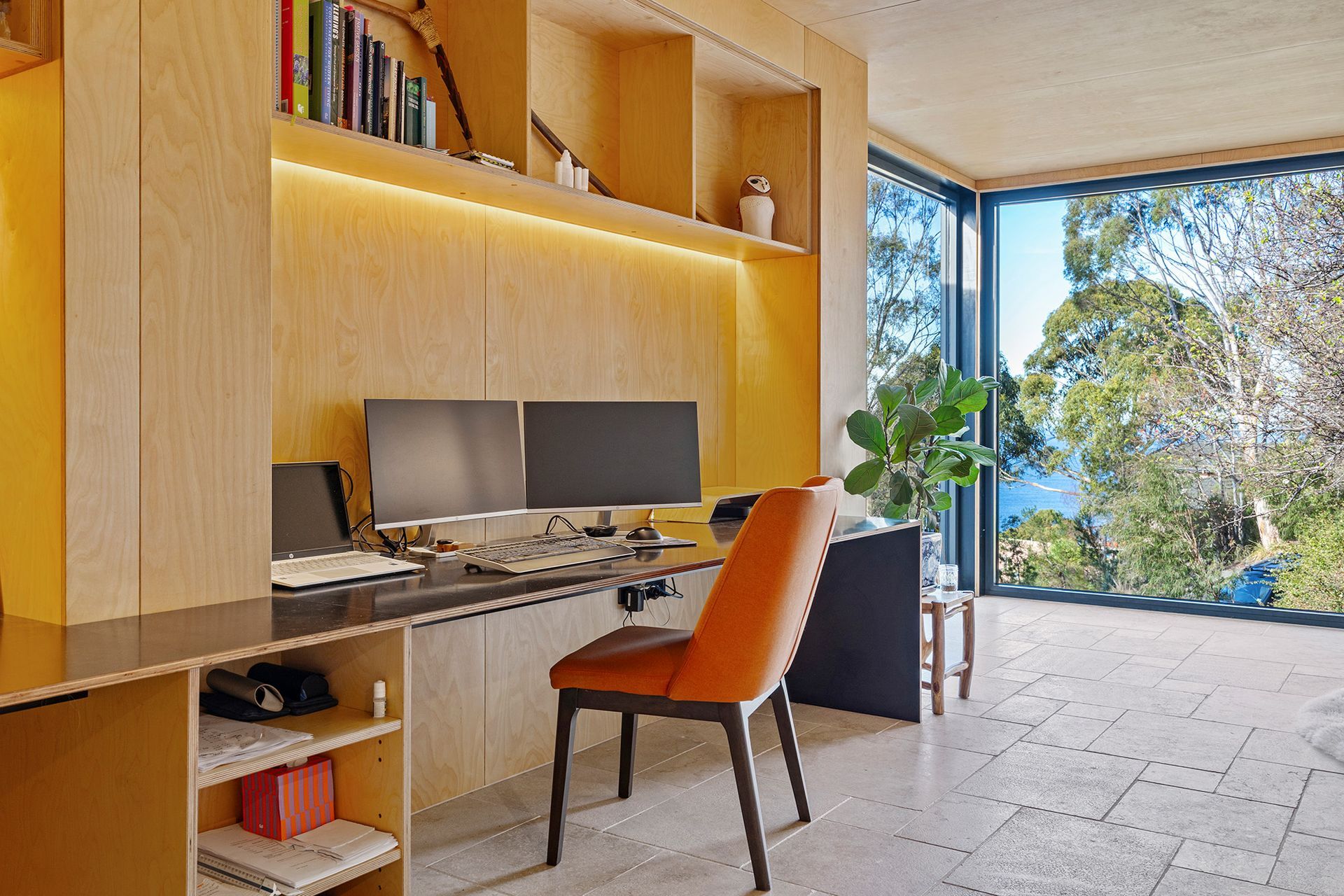 A home office with a desk , chair , and two computer monitors.