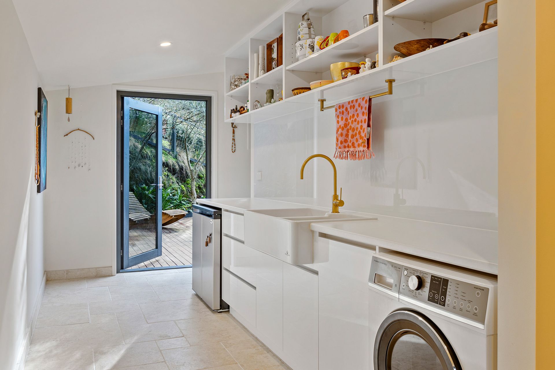 A laundry room with a washer and dryer and a sink.