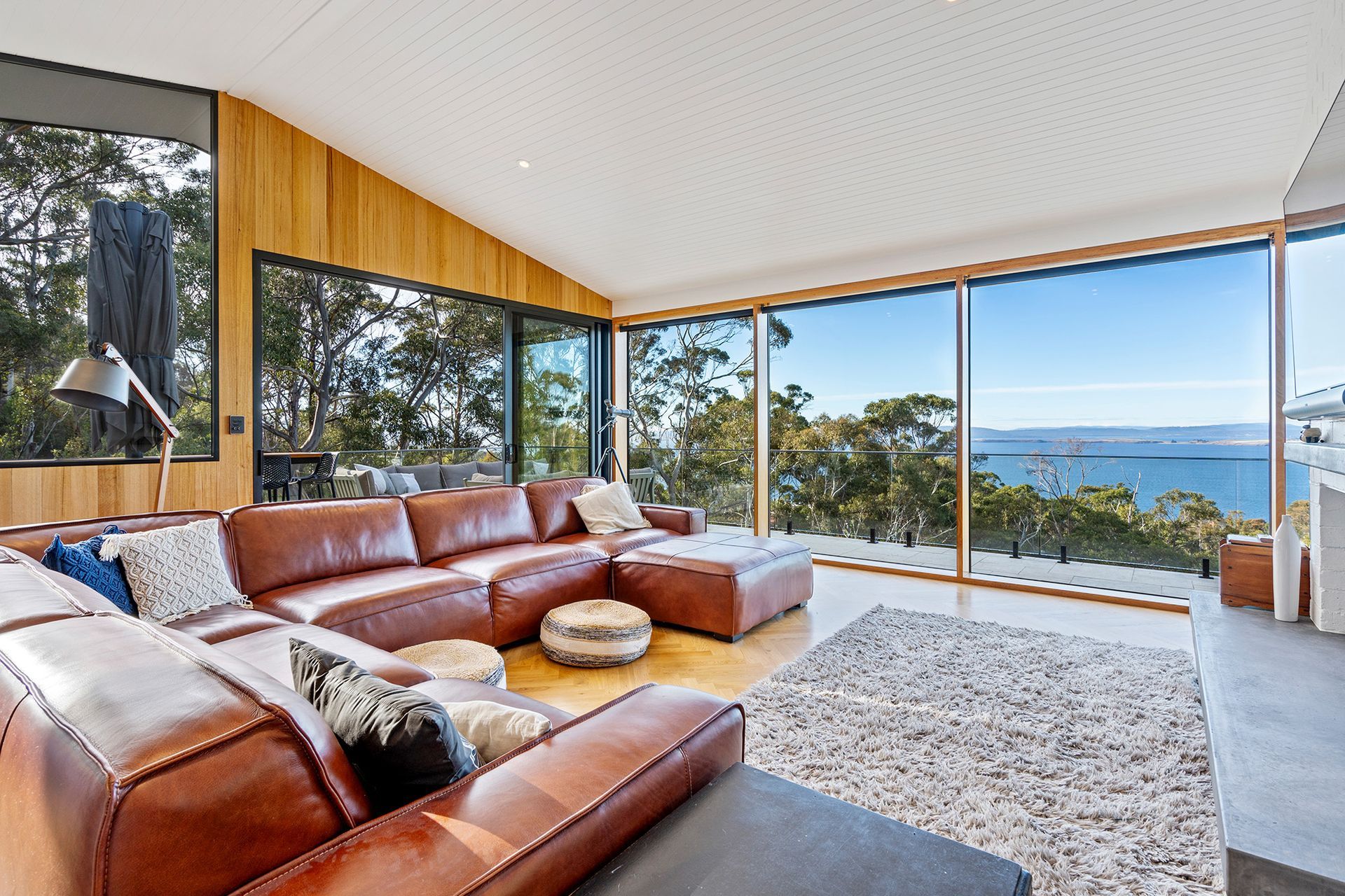 A living room with a couch and a view of the ocean