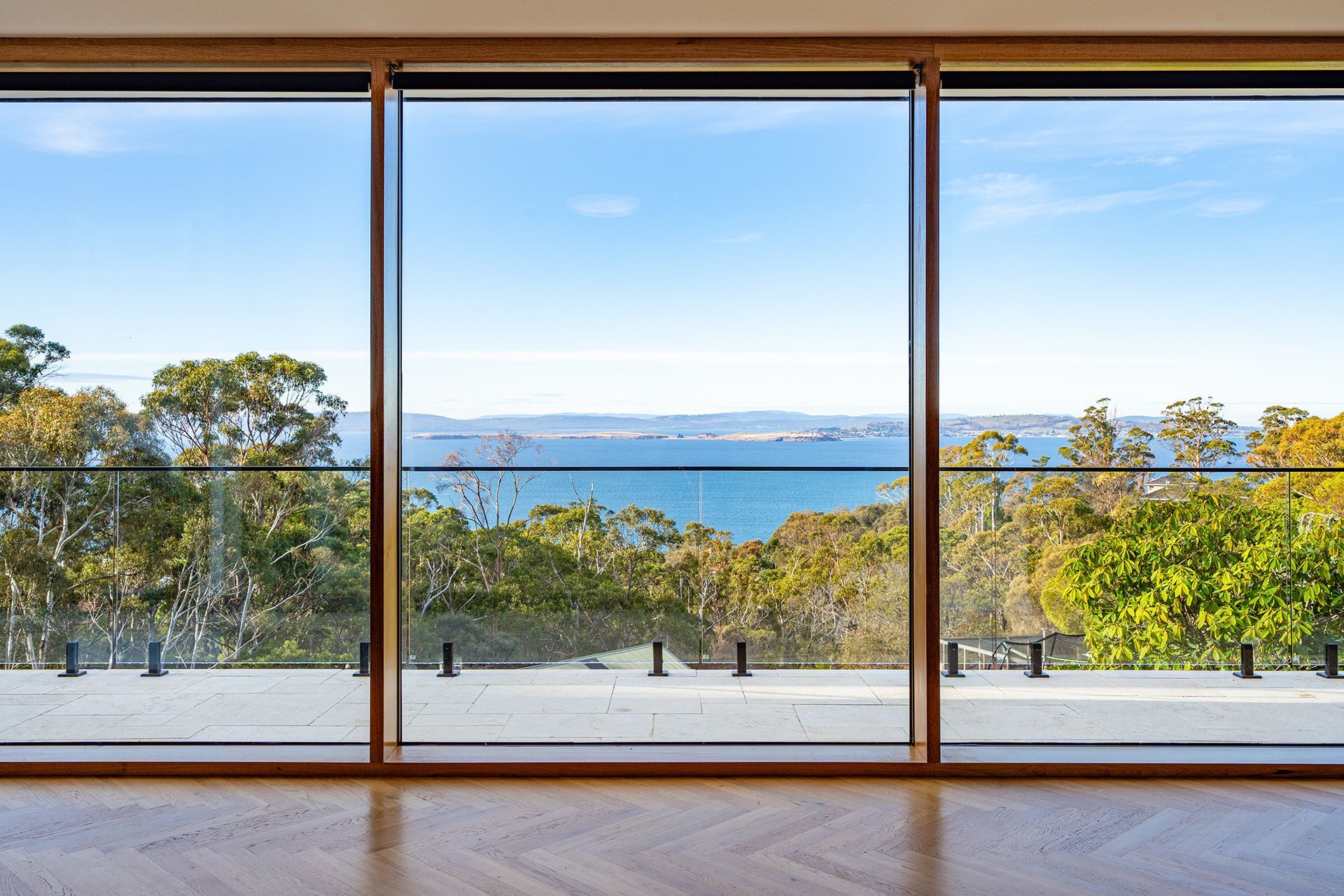 There is a large window with a view of the ocean.