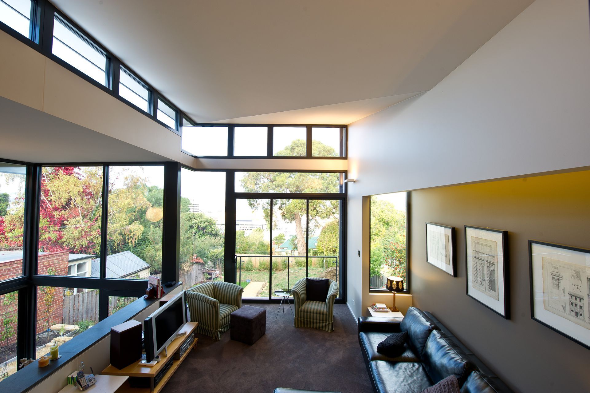 A living room with a lot of windows and a couch