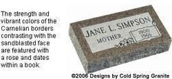 Granite gravestone with rose and scrollwork and a plaque reading “Jane L. Simpson”