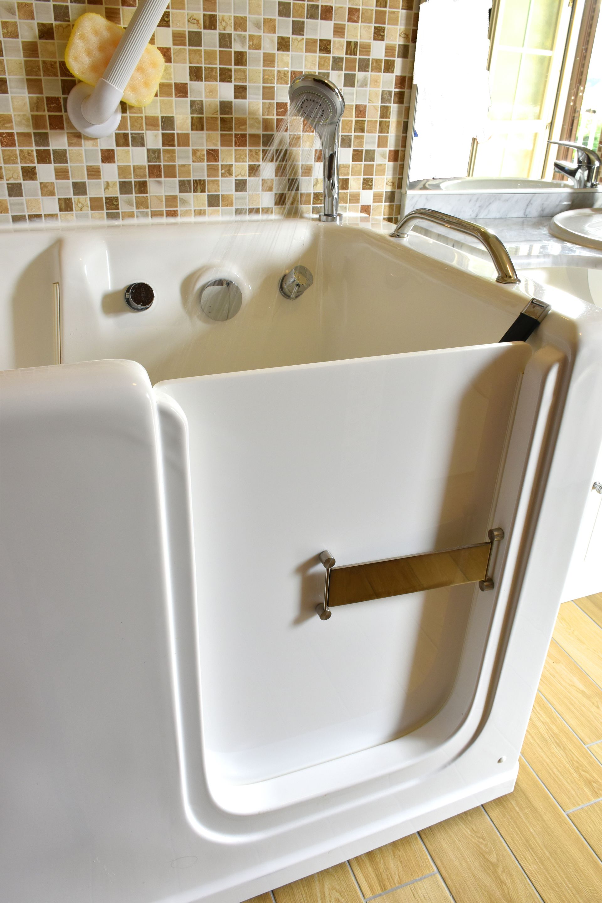 Silver stair lift beside beige carpeted stairs and a white door in a home entryway.