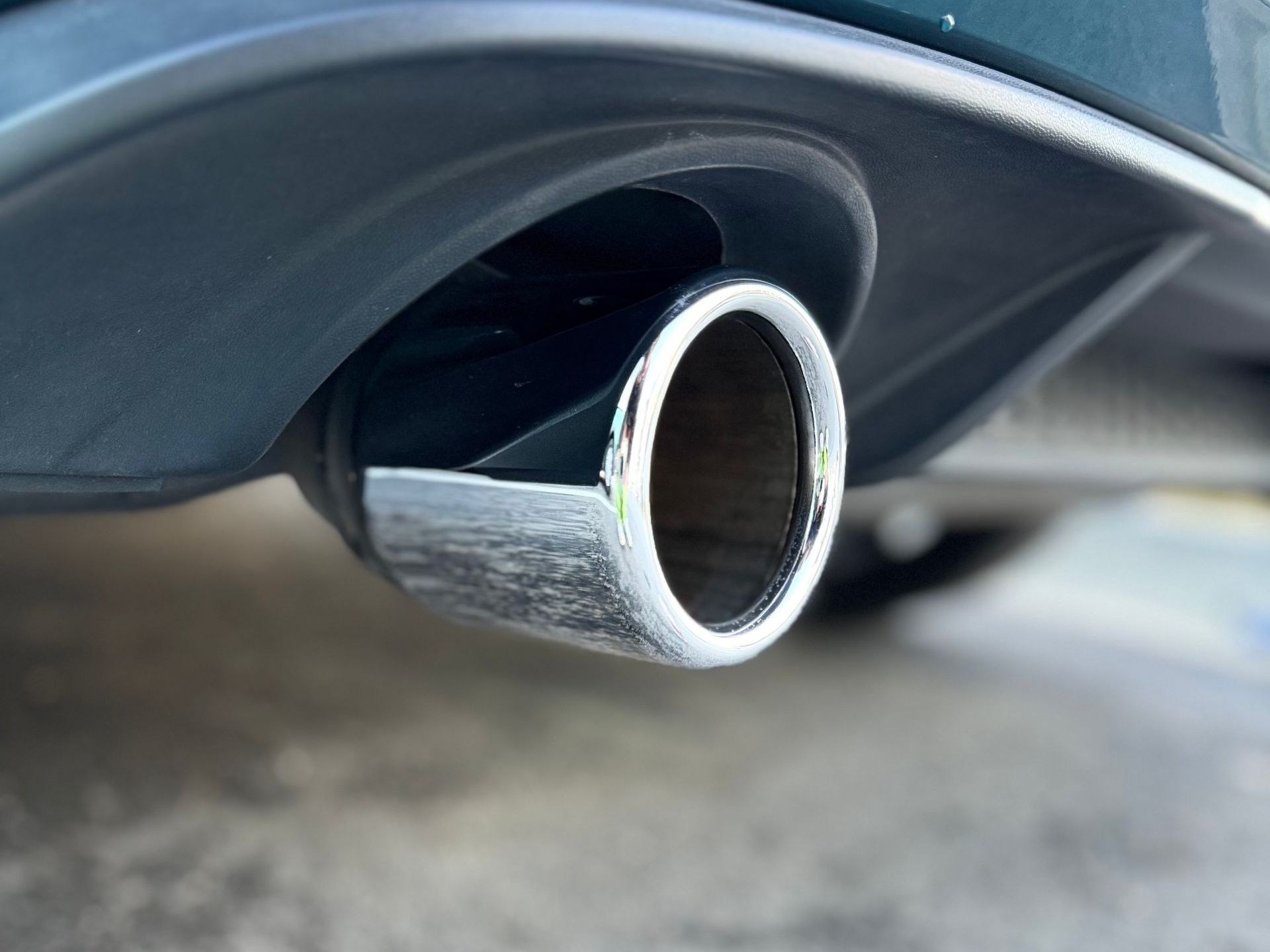 A close up of the exhaust pipe of a car.