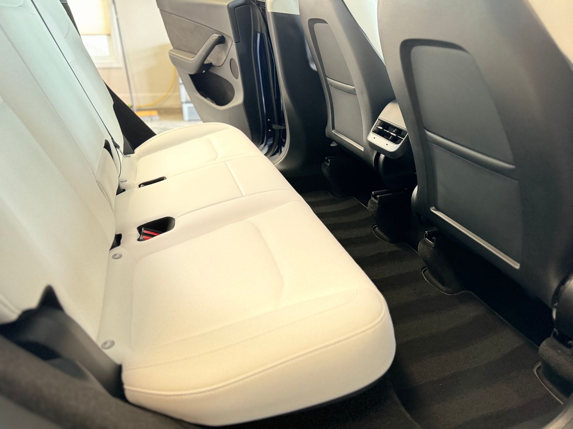 The back seat of a tesla model 3 is shown