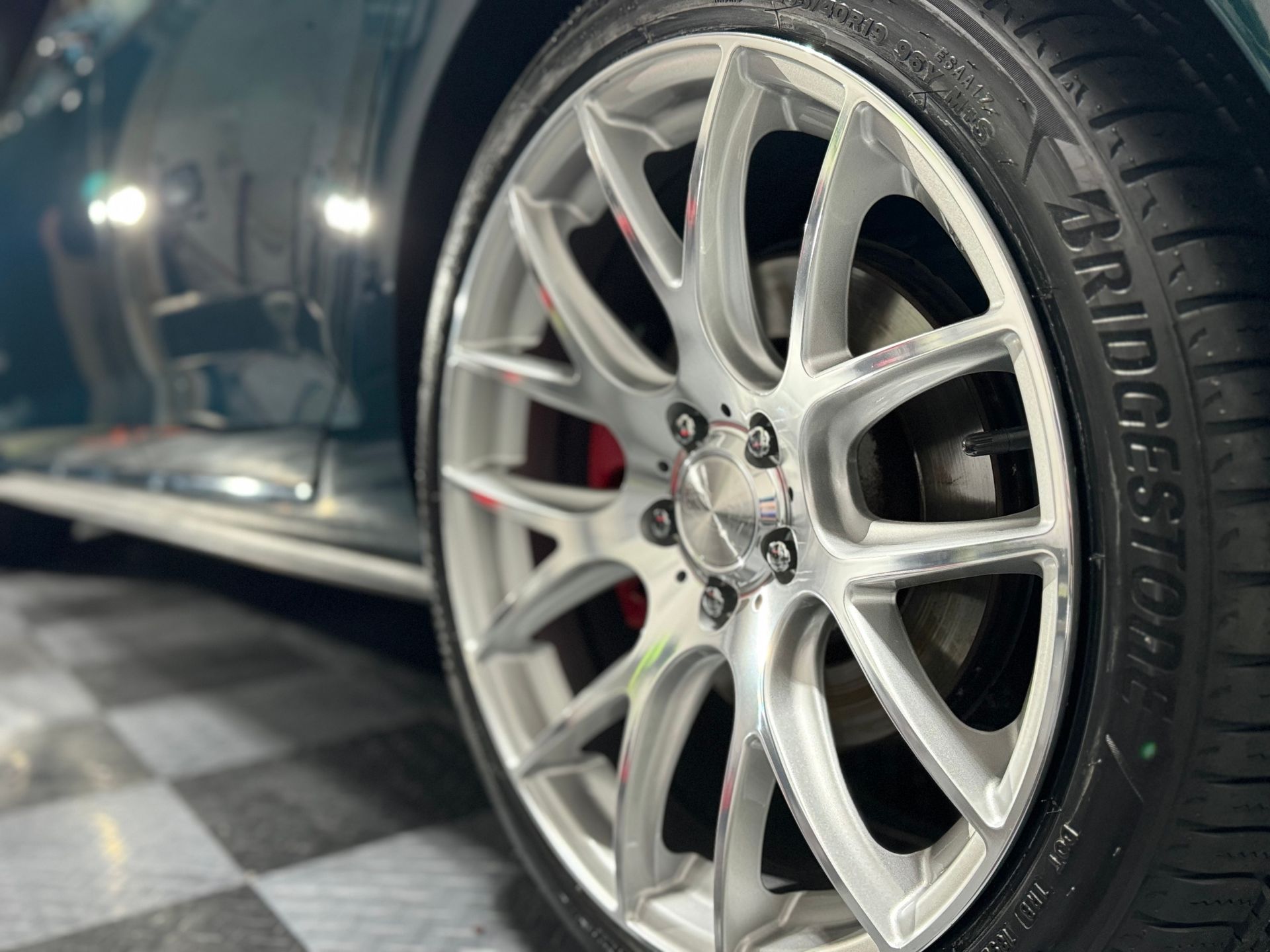 A close up of a bridgestone tire on a car