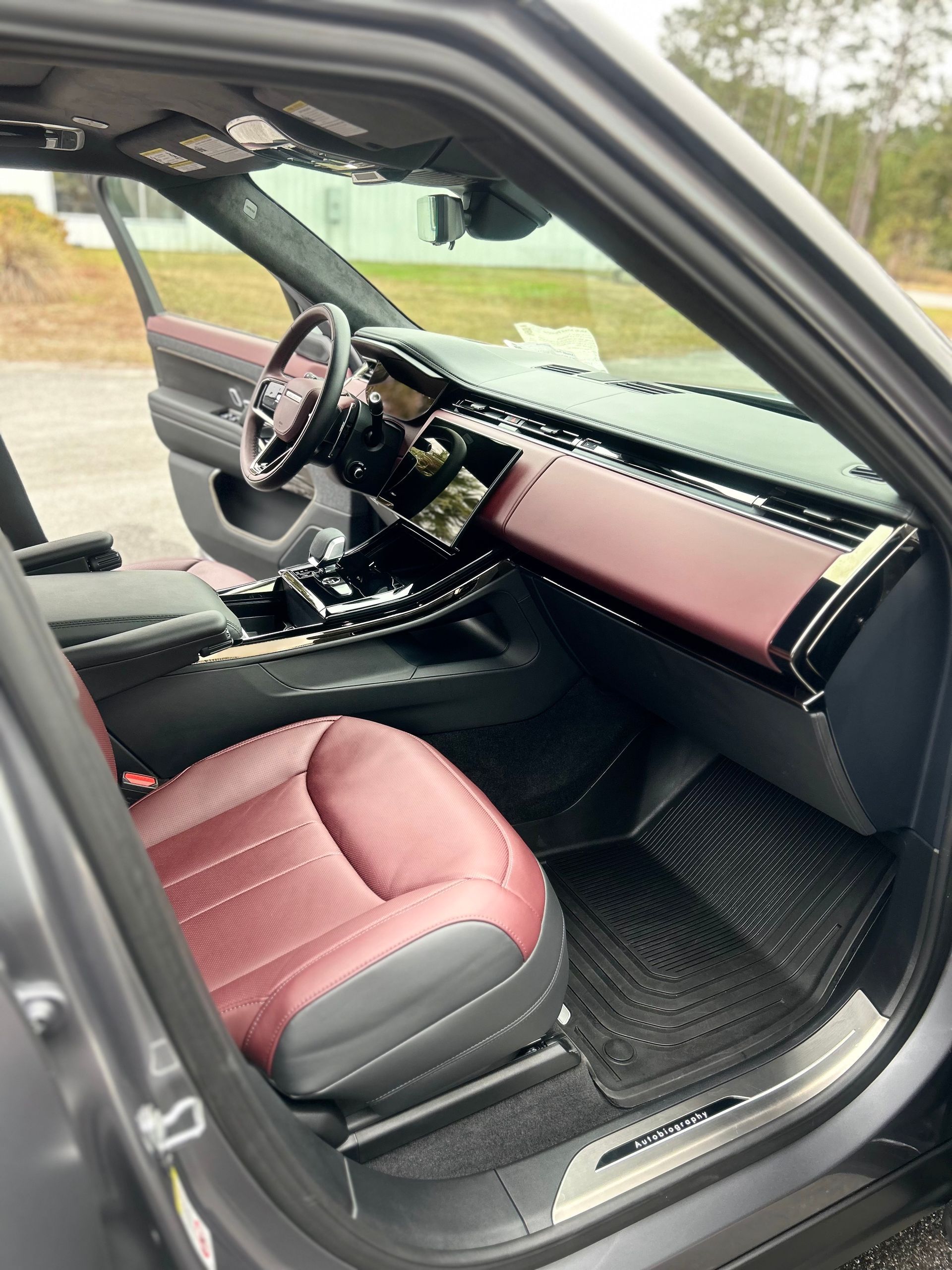 The interior of a green car with the door open