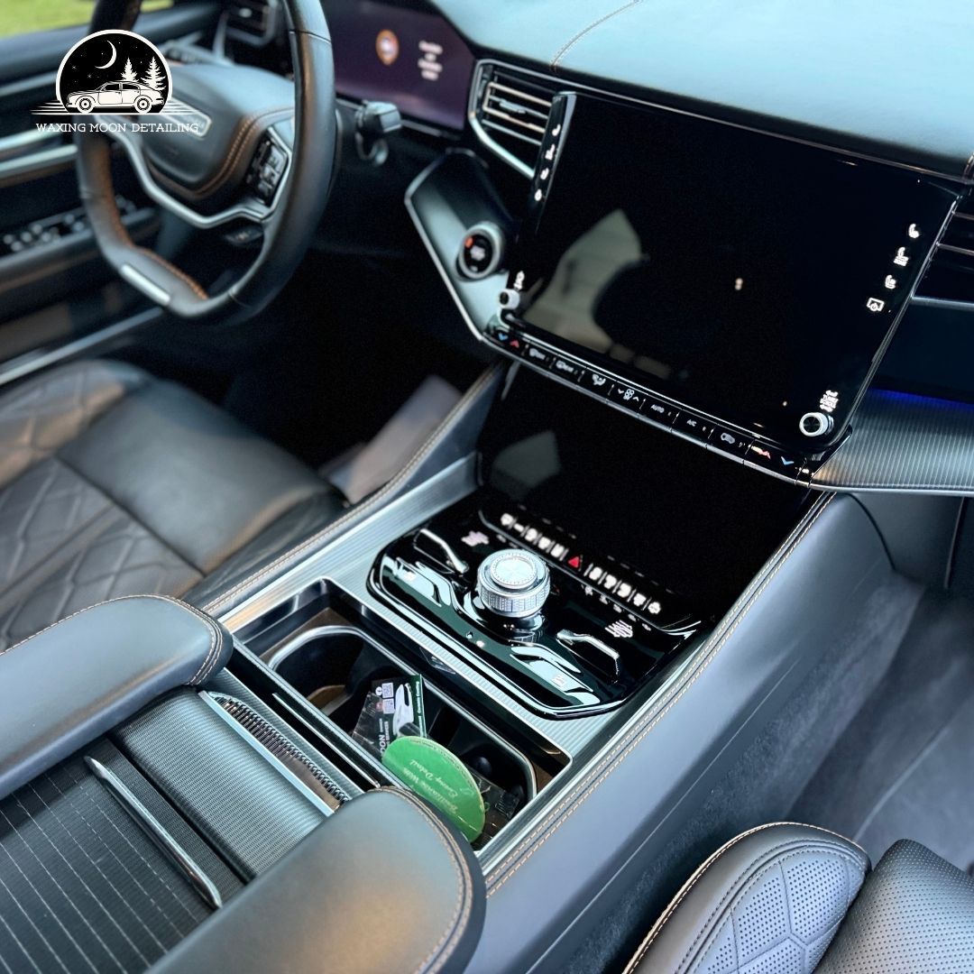 The interior of a car with a steering wheel and a dashboard