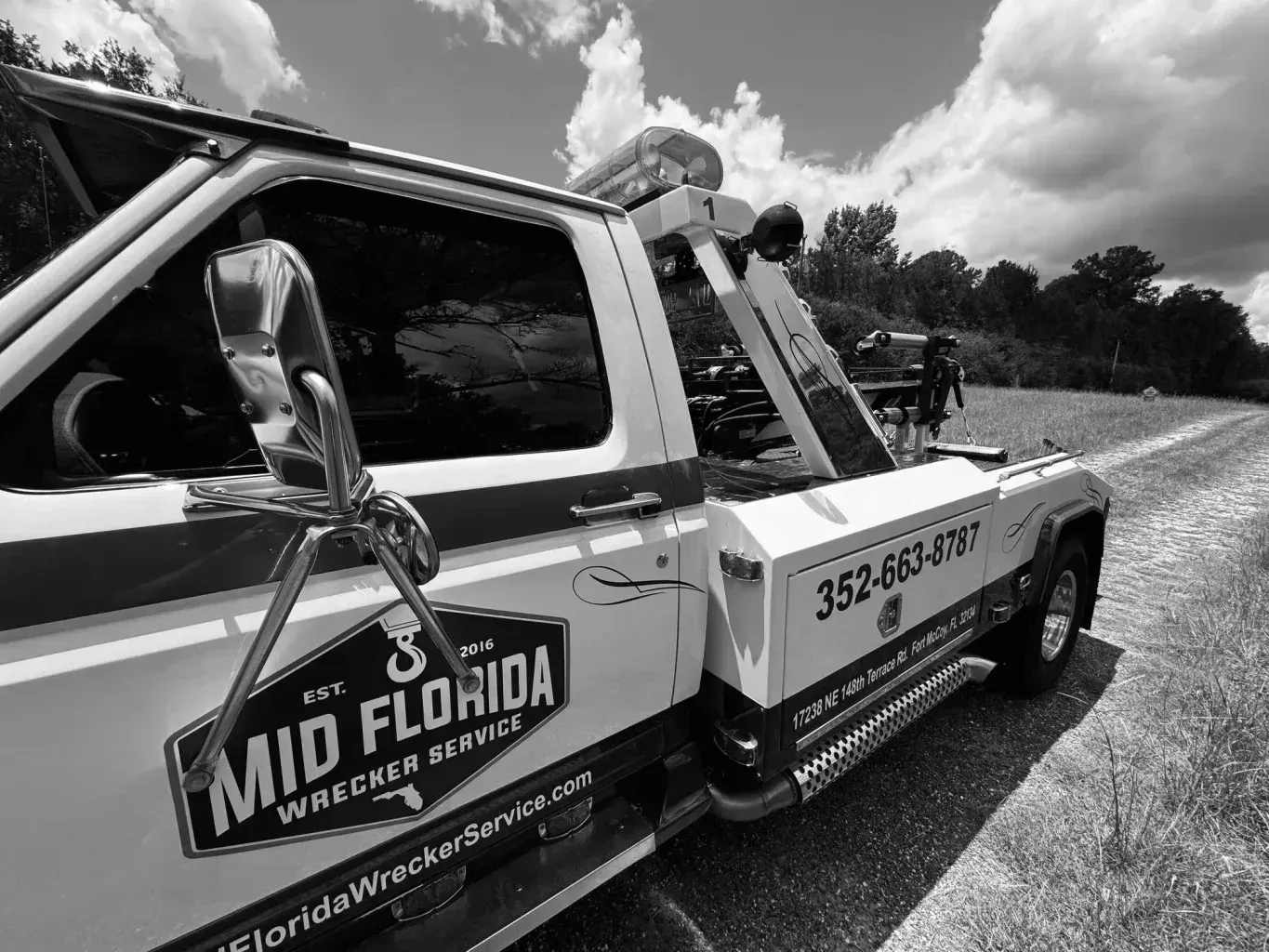 Black and white photo of a tow truck with 
